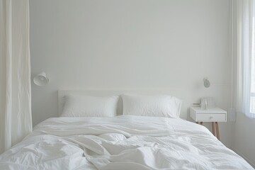 A minimal white bedroom with a simple bed, white linens, and a single nightstand, showcasing clean lines and a serene atmosphere