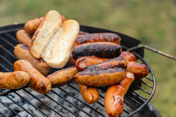 Sausages grilling on an outdoor barbecue
