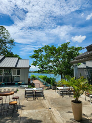 Coffee shop benches with blue water and a blue sky background in West Jakarta