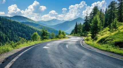 Winding asphalt road through a forested mountain landscape on a bright, sunny day