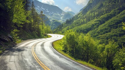 Fototapeta premium Winding asphalt road through a forested mountain landscape on a bright, sunny day