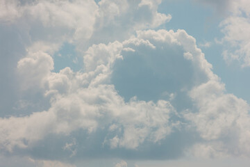 Reaching skyward, in mid-August, the billowing clouds are in costant slow motion over Harrington Beach State Park, Belgium, Wisconsin