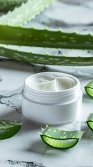 Cosmetic cream jar and green sliced stems aloe vera on marble background. Organic moisturizer face cream. Facial skin care and beauty treatment concept