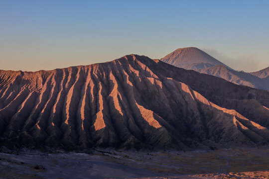 Mount Bromo at sunrise, capturing the majestic volcanic scenery, misty valleys, and vibrant hues, ideal for travel, nature, and adventure themes.