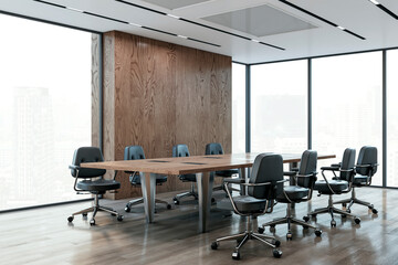 A modern conference room with a long wooden table, black office chairs, and large windows...
