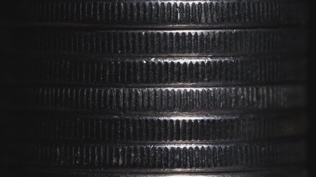 Stack of silver coins in close-up, texture of old coins, light moving 