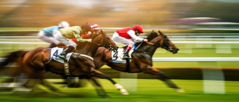 In the heat of the race, jockeys and their horses blur into speed, capturing the adrenaline and tension of horse racing.