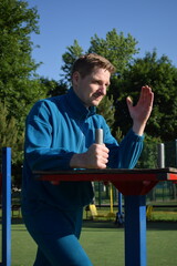 A dedicated young athlete puts in the hard work, vigorously training on gym equipment outdoors to...