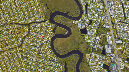 River separating cities, river between two settlements, looking down aerial view from above,...