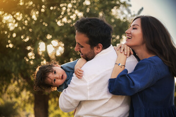 Happy Family Embracing in Nature