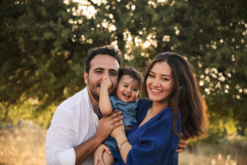 Happy Family Embracing in Nature