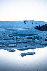 Melting glaciers during sunset. Global warming. Ice floes floating in the water. Untouched nature....