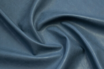 blue artificial leather with waves and folds on PVC base