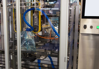 Automatic food packing machine. Food ingredients filling in plastic pouch package.