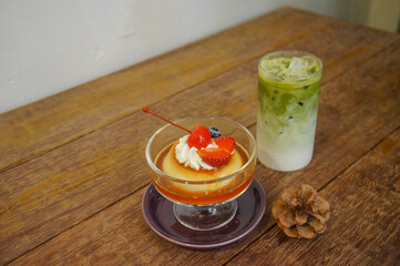 Pudding and green tea on a wooden table