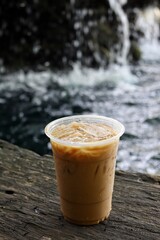 Iced coffee on brown wood background