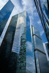 Tall office skyscrapers with sky reflection in windows, business concept banking background