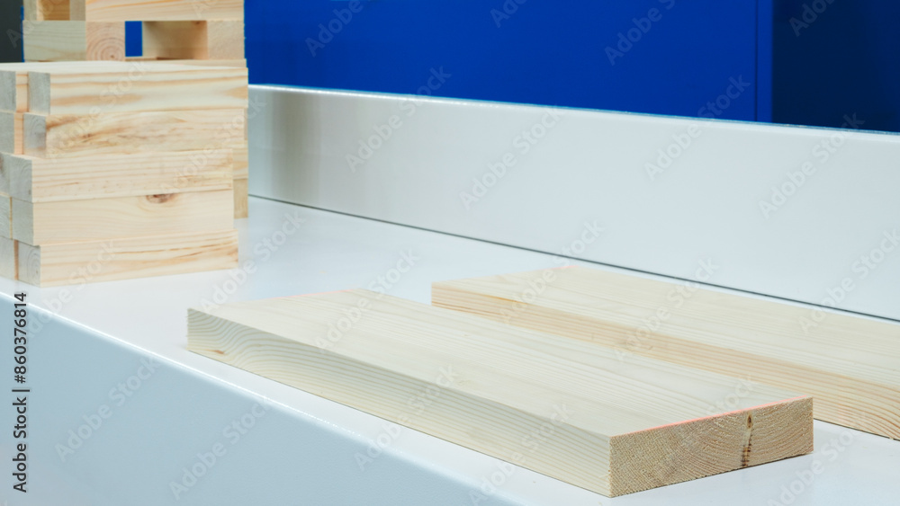 Poster A white counter top with a stack of wooden blocks on it. The blocks are of different sizes and are arranged in a way that they look like a puzzle. Concept of creativity and playfulness