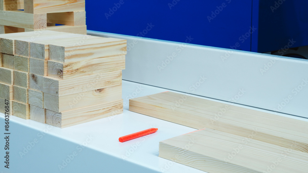 Poster A white counter top with a stack of wooden blocks on it. The blocks are of different sizes and are arranged in a way that they look like a puzzle. Concept of creativity and playfulness