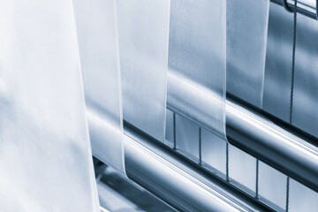 Automatic polyethylene plastic bag production machine with lighting effect. Close-up of the roller...