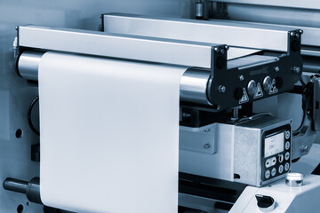 Automatic polyethylene plastic bag production machine with lighting effect. Close-up of the roller of the plastic bag production machine in the light blue scene. product packaging concept