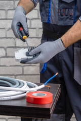  electrician works using screwdriver. electrician repairing.