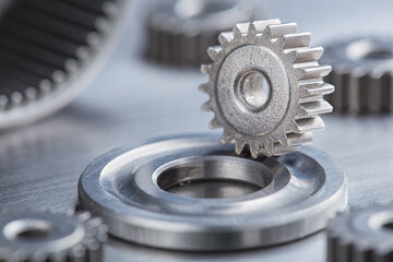 metal gears and bearings. Background with part of the mechanism.