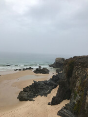 Rocky beach in fog, ocean coast