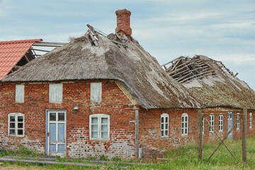 Ruined abandoned house with thatched roof in Sondervig Denmark