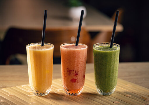 Three colorful fruit smoothies