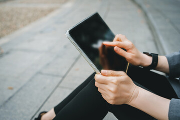 Hands Using Tablet Outdoors