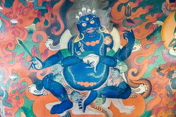 A detailed view of a vibrant tibetan deity painting displayed on a wall, Muney Monastery in Zanskar