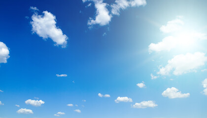 Blue sky with white clouds and sun. Wide photo.