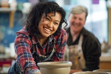 Obraz premium Happy woman making pottery in a studio with a friend.