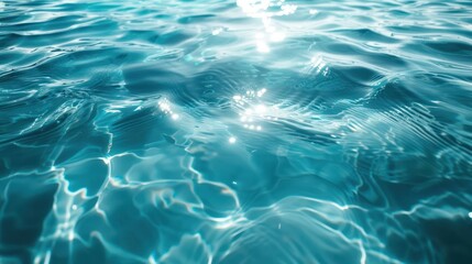 Obraz premium Crystal clear turquoise water surface with ripples and sun reflections. Perfect for summer, beach, and nature themes.