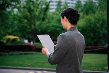 Businesswoman Using Tablet in Park