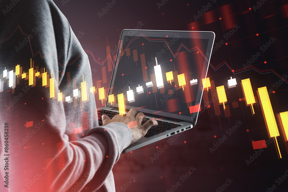 Poster hacker using laptop with falling forex chart hologram on blurry background. financial crisis, hackin