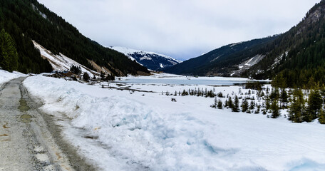 Mountain lake near K&ouml;nigsleiten in Austria. Snowy road and frozen lake in the Alps.