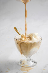 vertical of affogato being prepared with espresso poured over vanilla ice cream in a glass cup