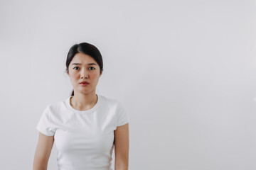 Asian Thai woman doubt and curious face, have question thinking and looking at camera, isolated on white background wall.