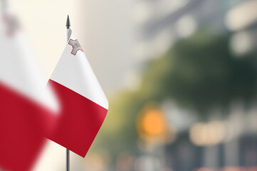 Small flags of Malta on a blurred background