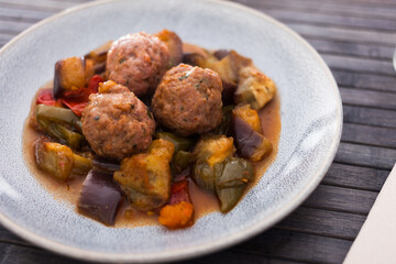 Cooked meatballs with stewed eggplant with haze in bowl