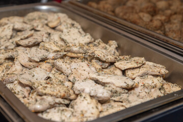 Herb garlic chicken, catered at an event. Chicken served in a warming tray. 
