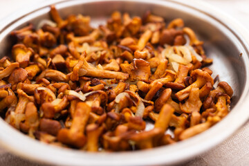 Delicious fried chanterelle mushrooms in a frying pan
