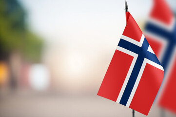 Small flags of Norway on a blurred background