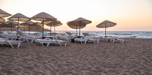 Empty sun loungers on the beach in evening time