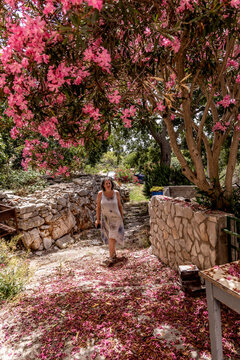 Woman strolling through the streets of the decaying village of Zirje on the island of the same name in Croatia