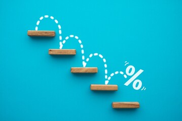 Percent sign moving down from top stair on blue background. Central banking system of the United...