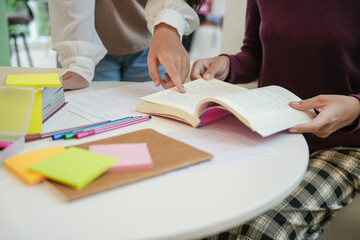 Learning with friends Young students campus.High School Tutor for examining helps school homework together with friend catching up and learning