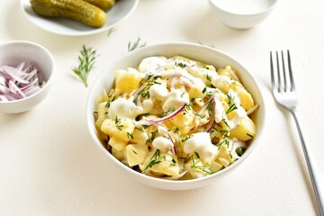 Potato salad with egg, pickle, red onion with mayonnaise and yogurt dressing